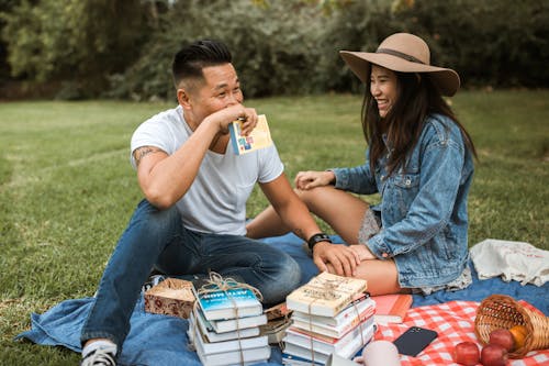 Couple Reading Book on a Picnic