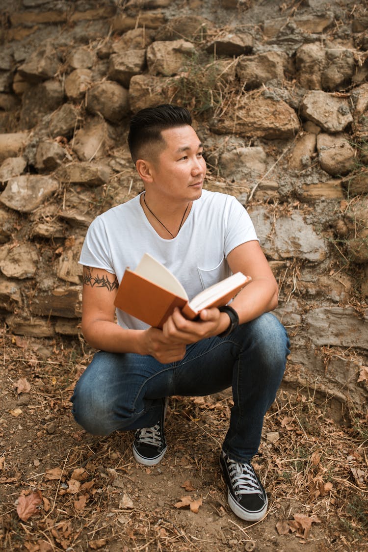 A Man Holding A Book