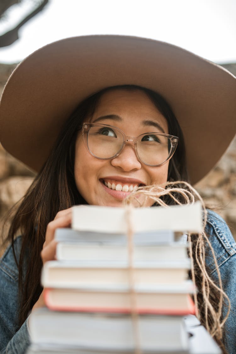 A Woman A Stack Of Books