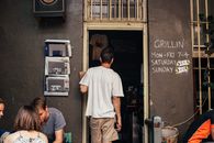 Unrecognizable man standing at entrance of cafe