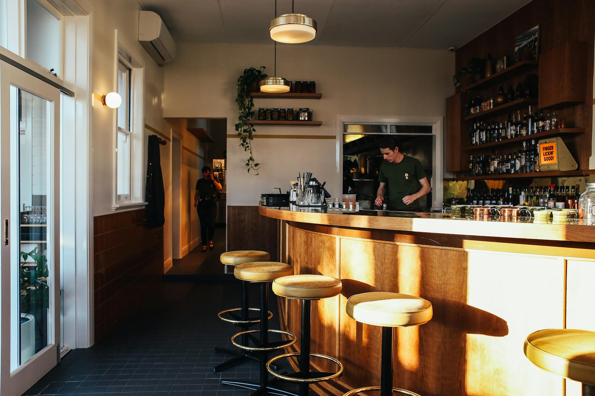 Stools, Bar Counter and Bartender in Restaurant