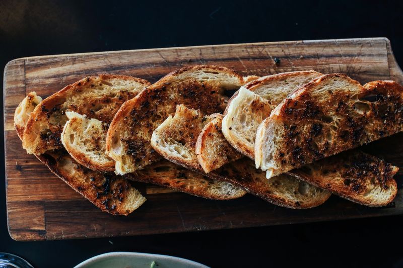 Toasted sourdough with breakfast toppings on a bakery table