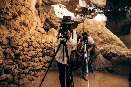 Capture of photographers in action within a mysterious cave setting.