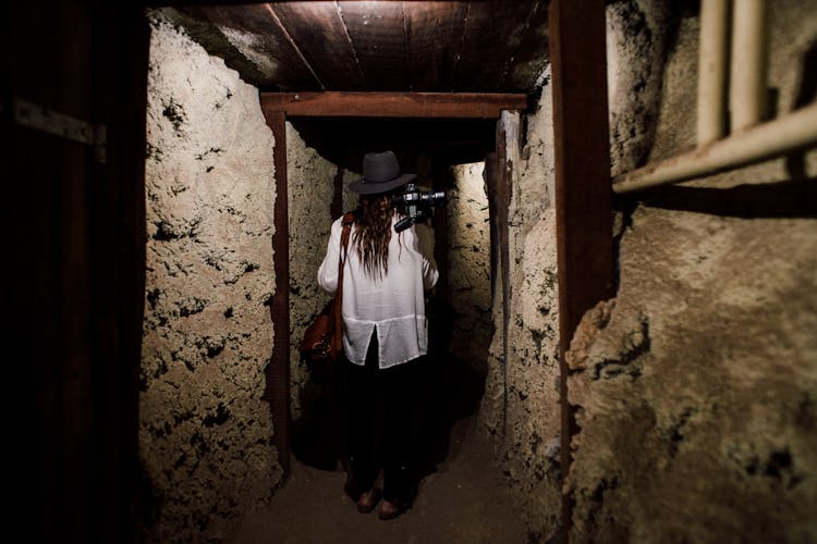 Woman With Camera Walking In Undergrounds
