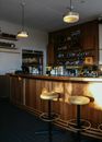 Brown Wooden Bar Counter With Bar Stools