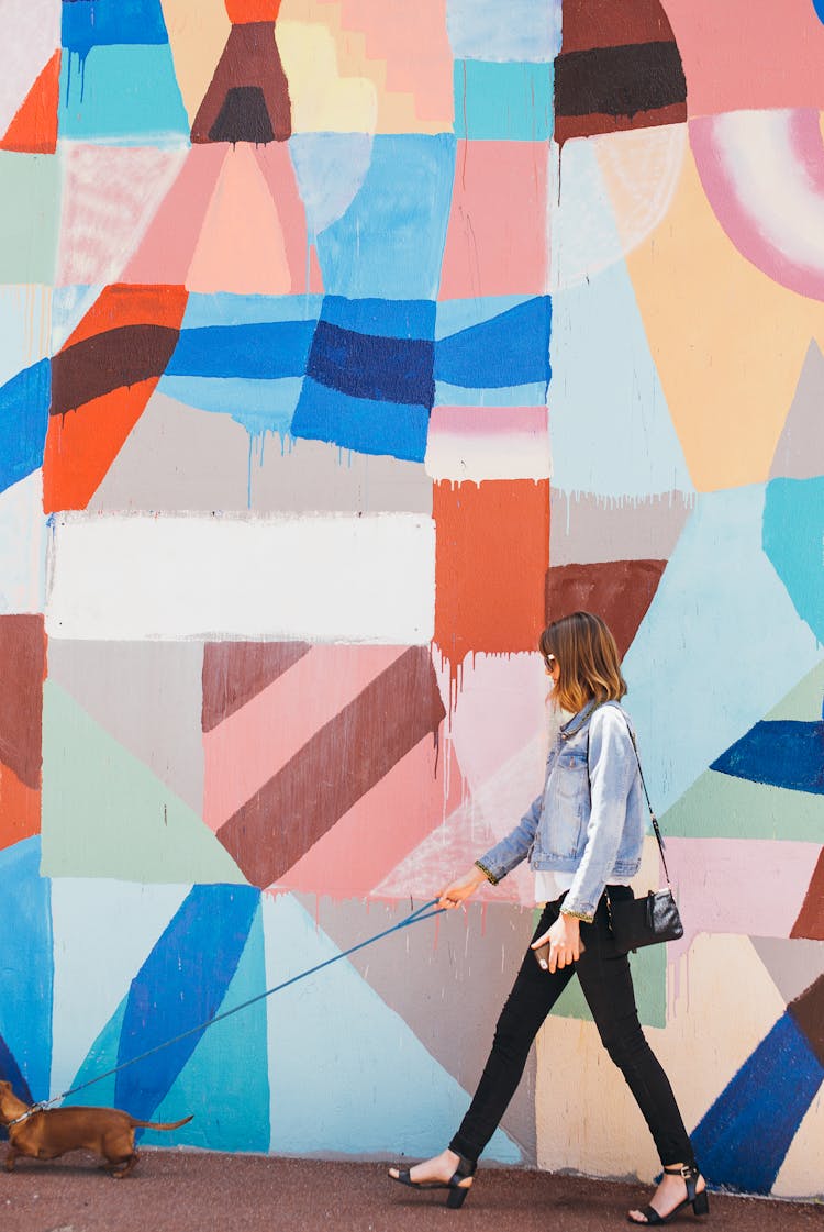 Woman Walking Her Dog In A City 