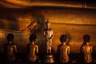 Gold Buddha Figurine on Brown Wooden Table