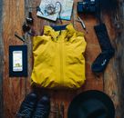Black and White Socks Beside Black Leather Shoes and Black Leather Bag on Brown Wooden Table