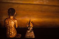 Gold Buddha Figurine on Brown Wooden Table