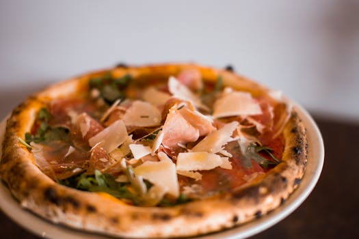 Close-up of a gourmet pizza with Parma ham and Parmesan cheese, showcasing Italian cuisine.