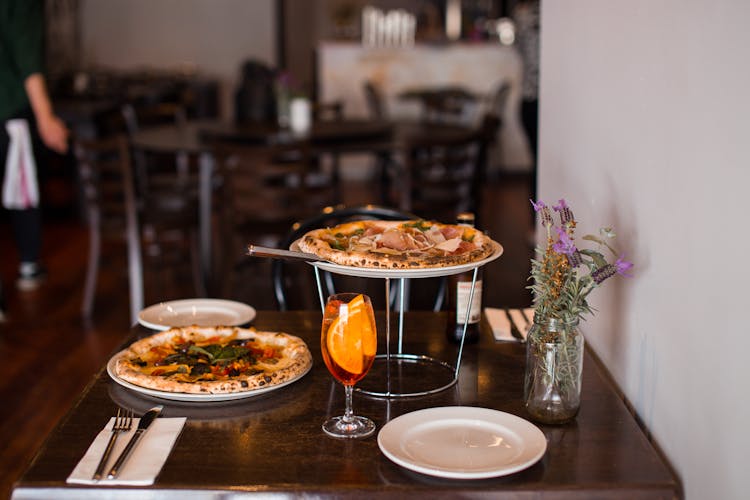 Cocktail And Pizza On Restaurant Table