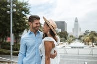 Man in Blue Denim Button Up Shirt and Woman in White Lace Dress