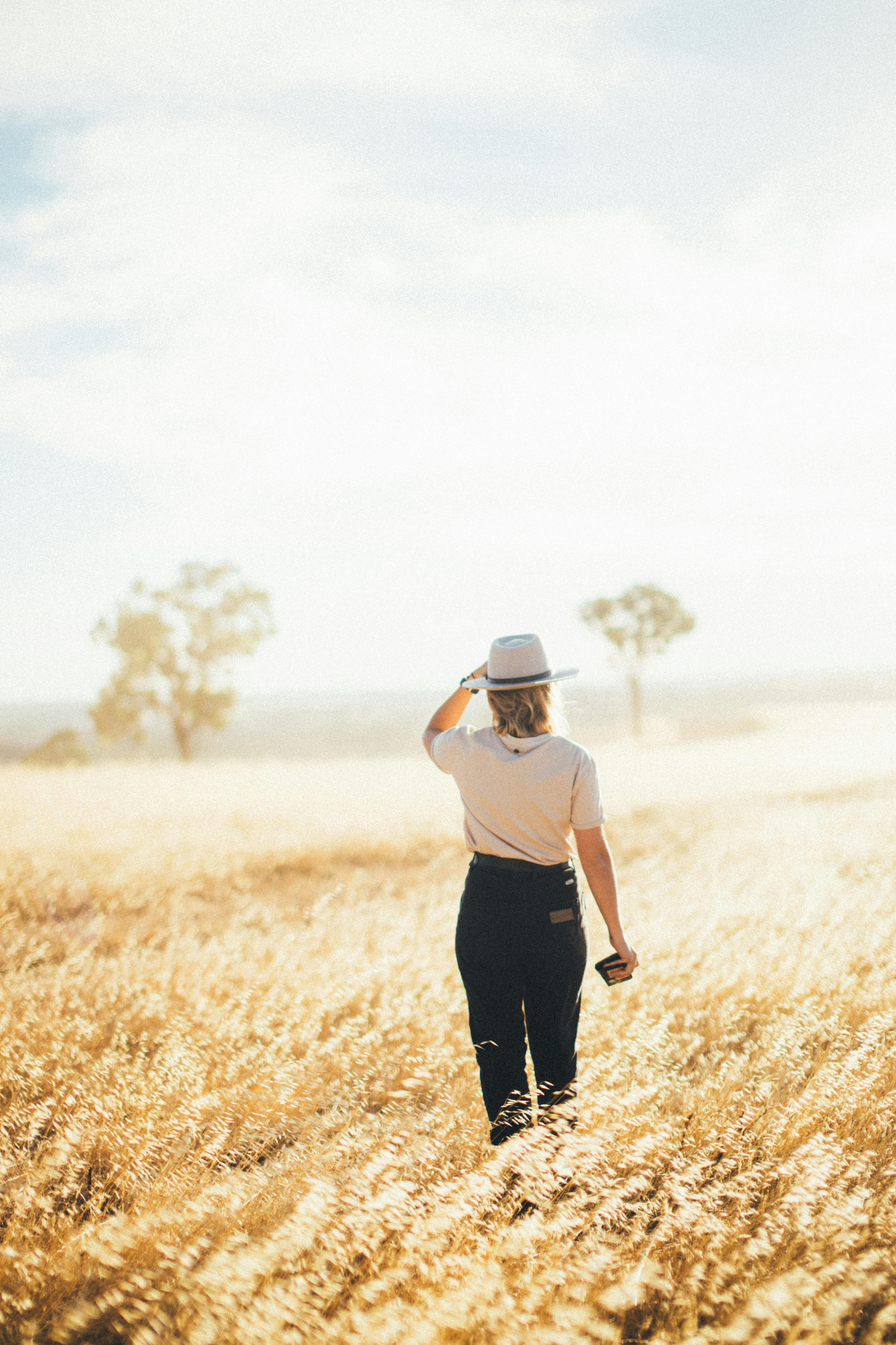 back view of a person standing on the grass field