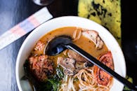 White Ceramic Bowl With Noodles and Stainless Steel Spoon