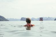 Woman in Pink Bikini Swimming on Sea