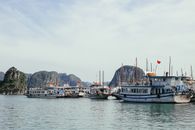 Boats Docked by Rocky Sea 