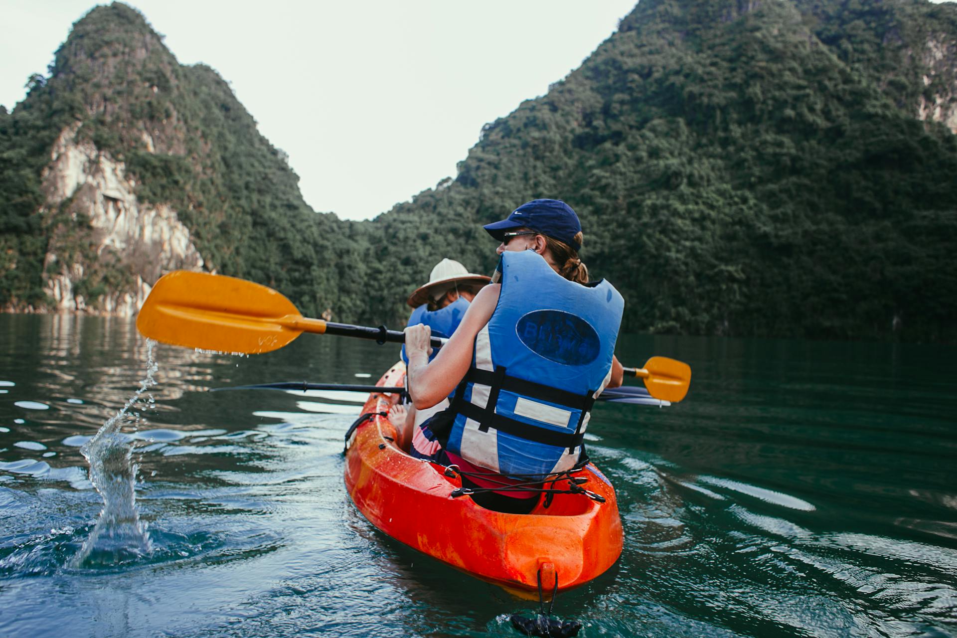 Enjoy a thrilling kayaking experience in stunning coastal waters surrounded by lush mountains.