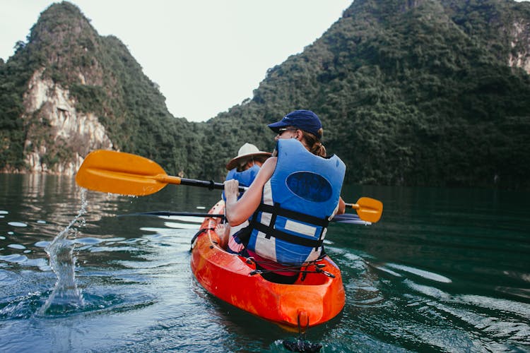 People Kayaking On The Sea