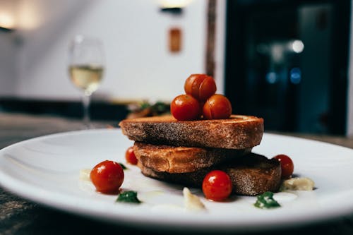 Toasted Bread With Cherry Tomatoes on White Ceramic Plate