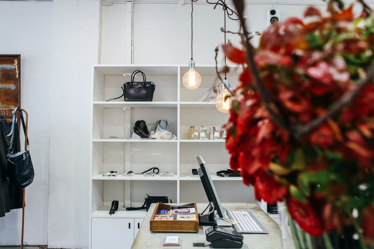 Boutique retail store with display shelves, handbags, and a register counter to plan around when you move a retail store