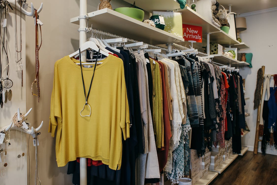 Free Apparels Hanging on Racks in a Boutique Stock Photo