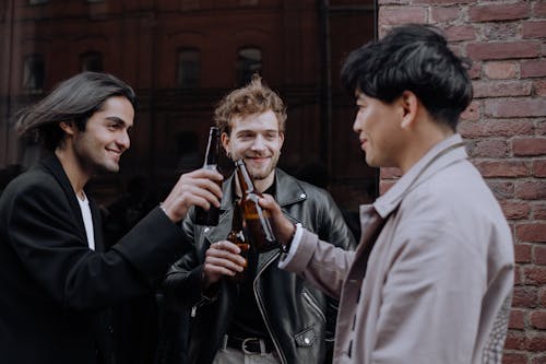 Free Men Drinking Beers in the Street Stock Photo