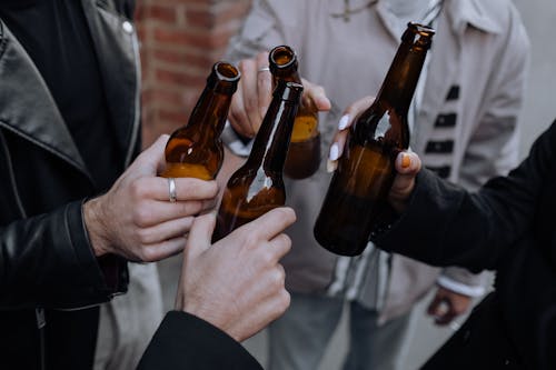 Free People Holding Bottle of Beers Stock Photo