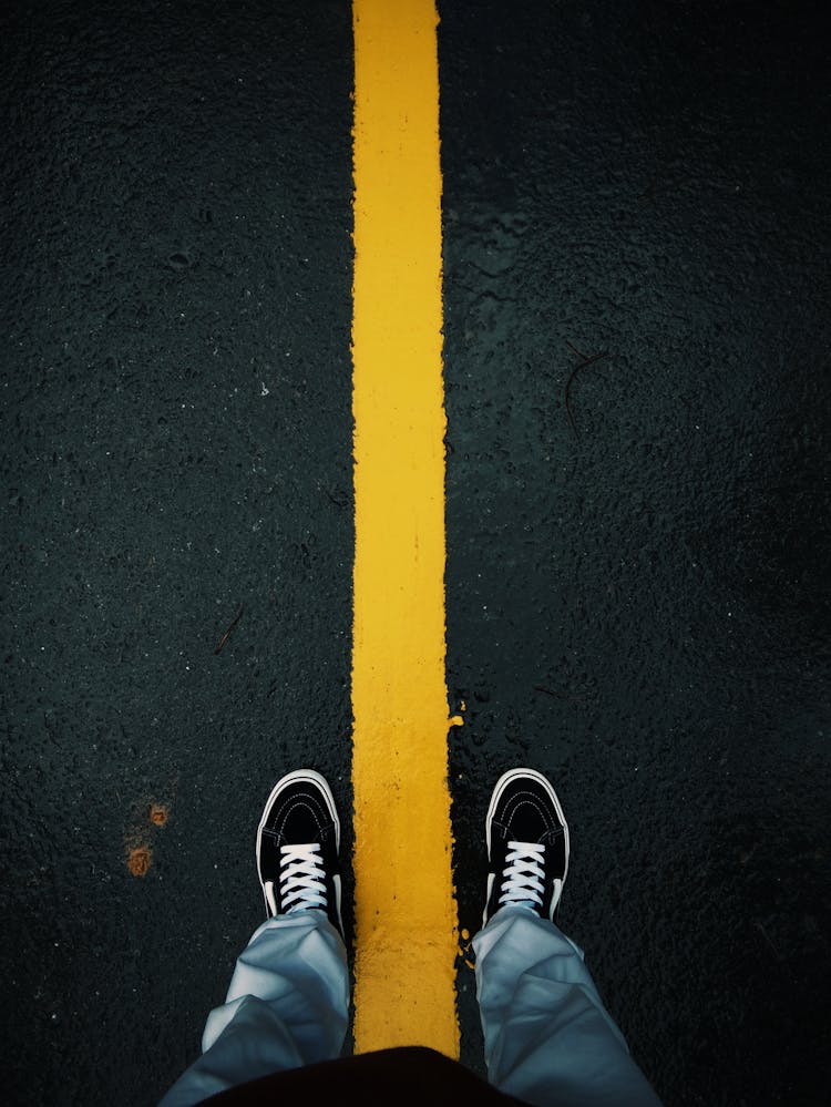 Person Legs And Feet On Asphalt