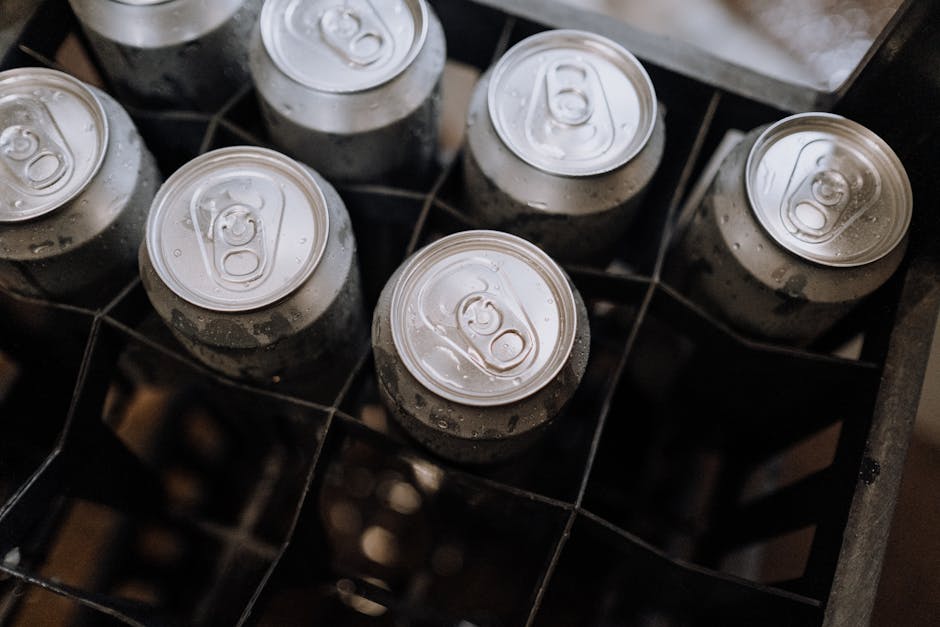Top-down photo of aluminum beverage cans with condensation in a crate.