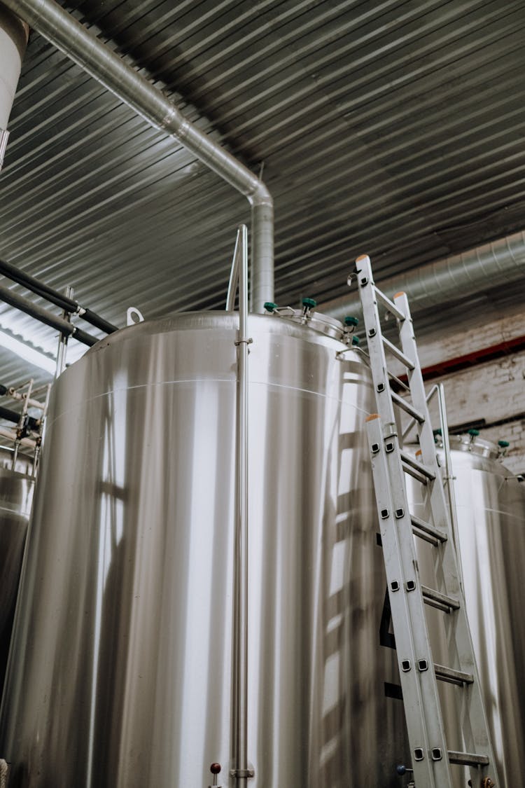 A Steel Ladder Leaning On Stainless Steel Tank