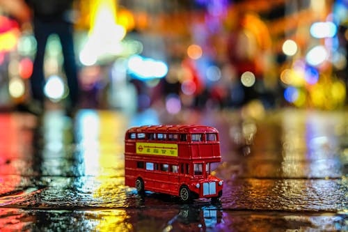 Free Red Bus Toy on Road Stock Photo