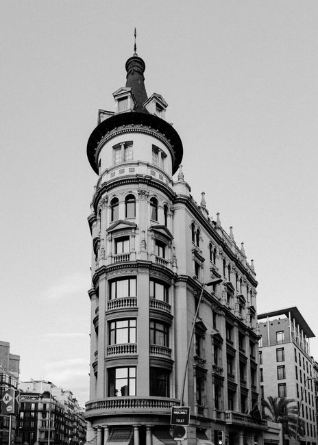 Black and white photograph of a historic building in Barcelona, capturing its unique architectural style.