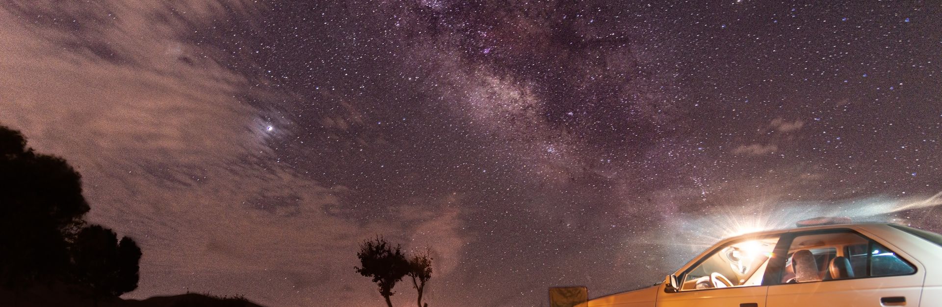 Experience a mesmerizing night under the Milky Way with a cozy campfire and distant stars in Borouje