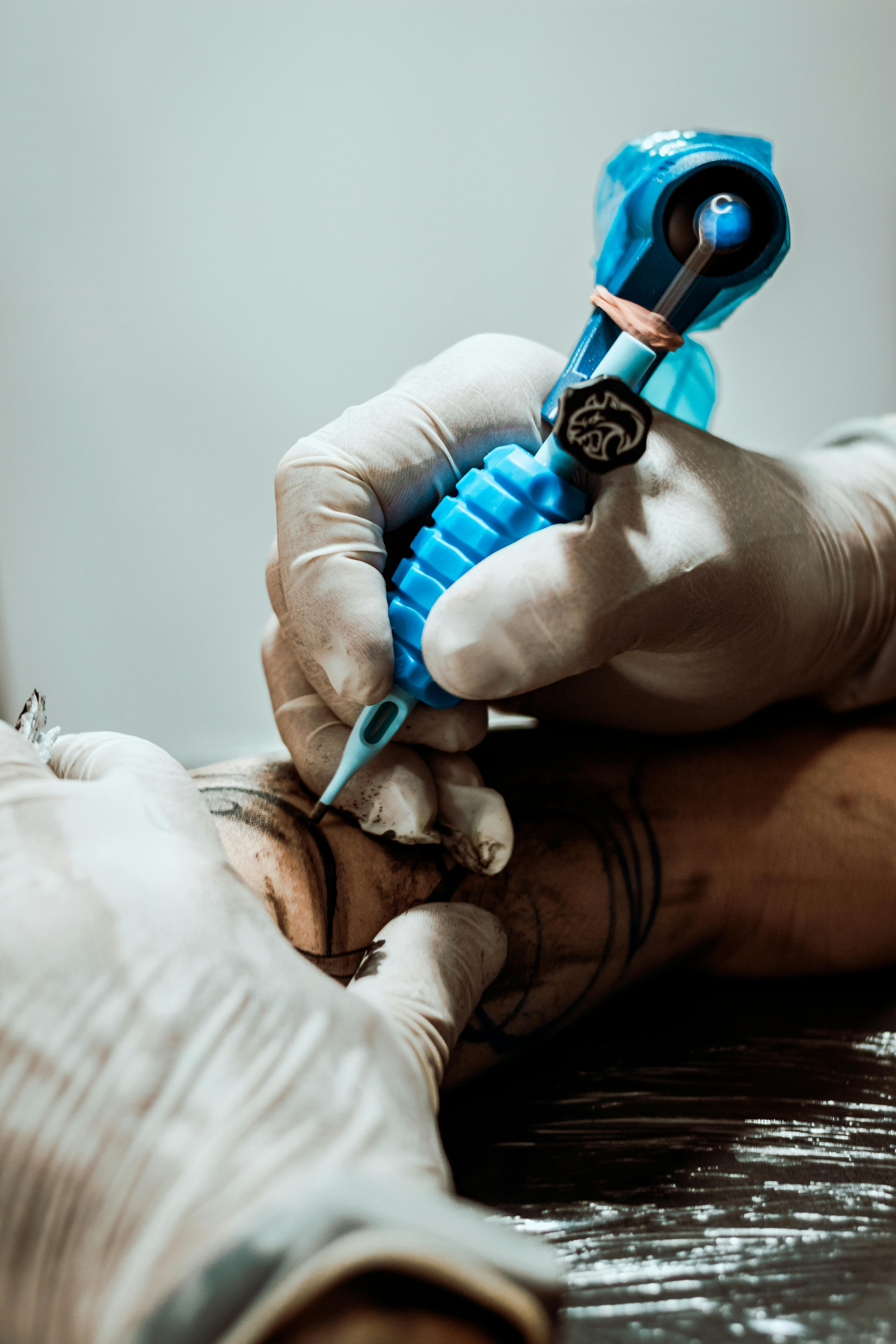 Crop tattooist making tattoo on arm · Free Stock Photo