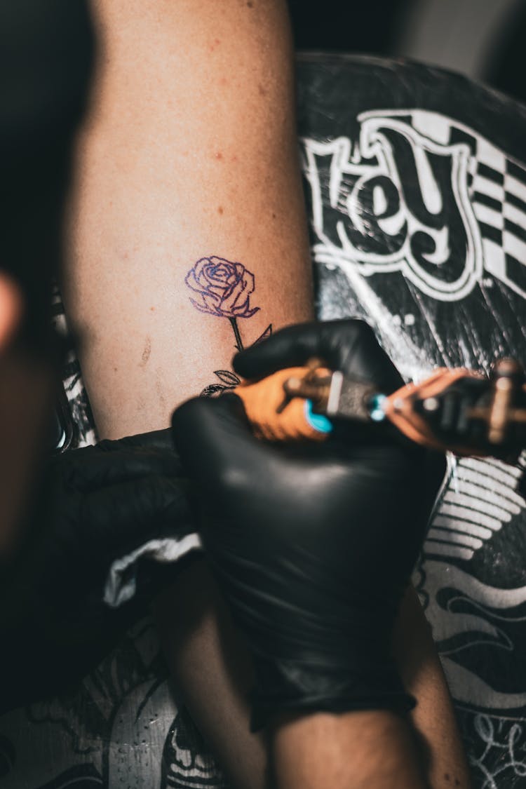 Crop Master Making Tattoo On Arm