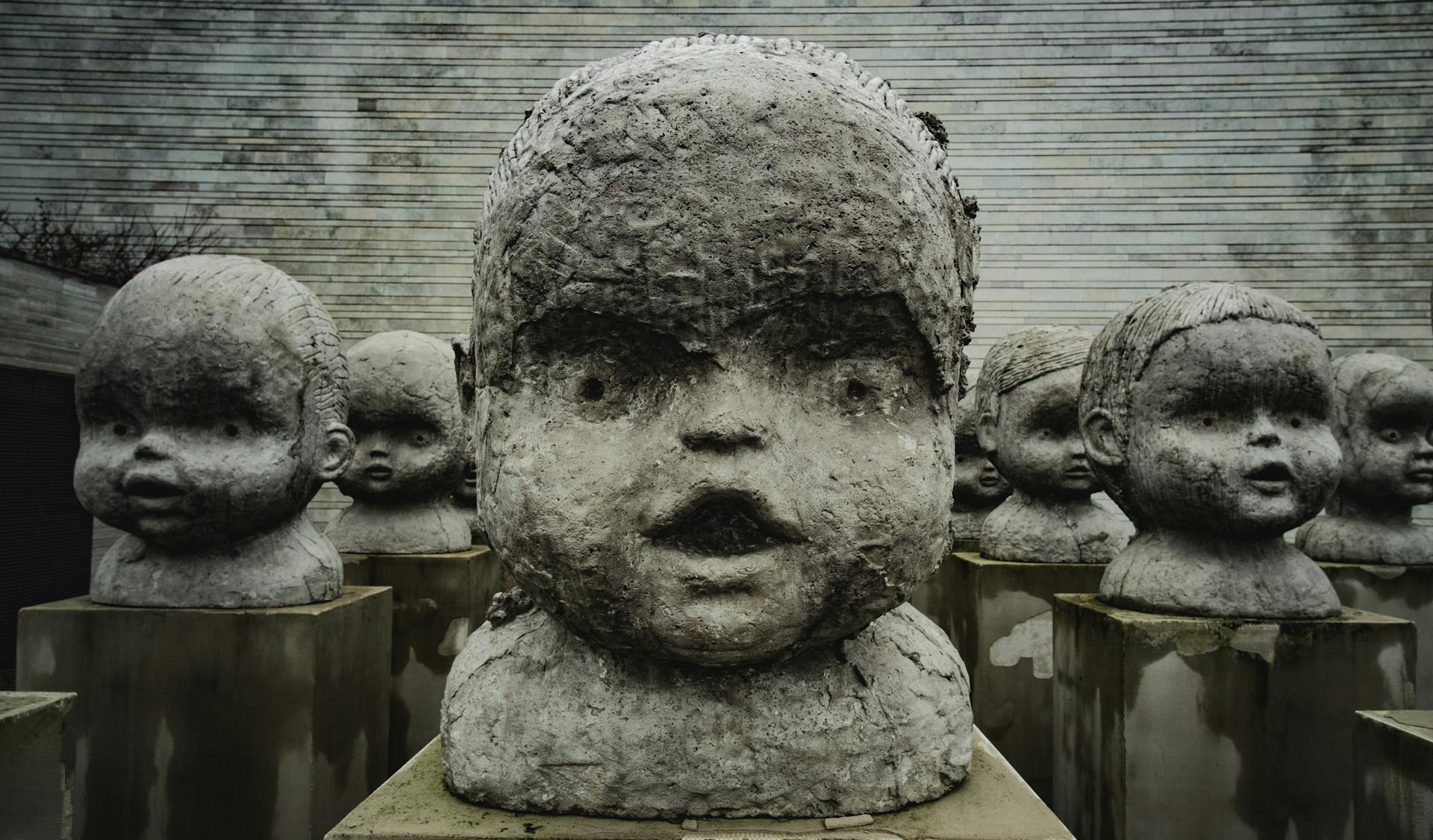 Close-up of unsettling baby sculptures in a Tallinn art museum exhibit.