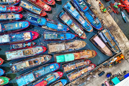 Free Vibrant aerial shot of docked boats at a busy Jakarta harbor pier. Stock Photo