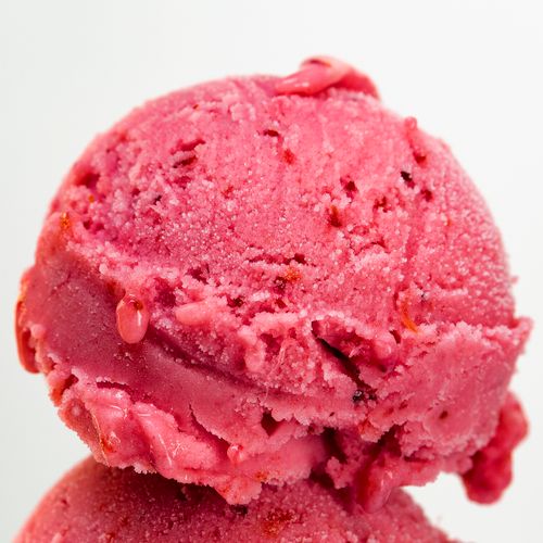 Free Mouthwatering strawberry ice cream scoop close-up with vibrant pink color and textured details. Stock Photo