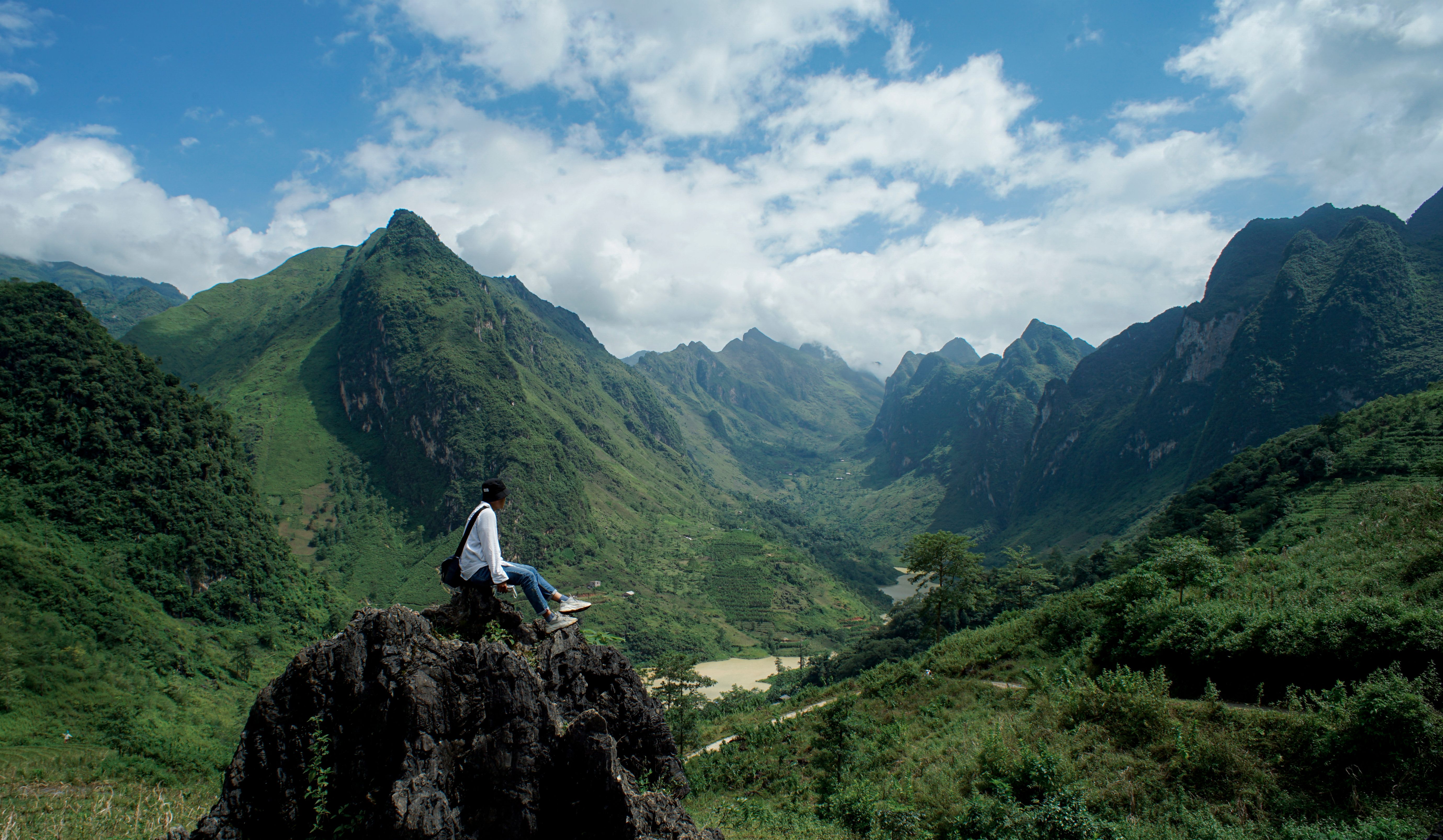 A Man Sitting on the Top of a Mountain · Free Stock Photo