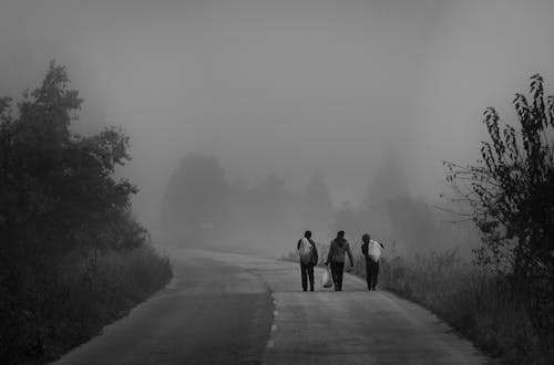 Grayscale Photo of People Walking on the Road