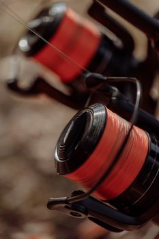 Detailed close-up of fishing reels with vibrant red lines, perfect for angling enthusiasts.
