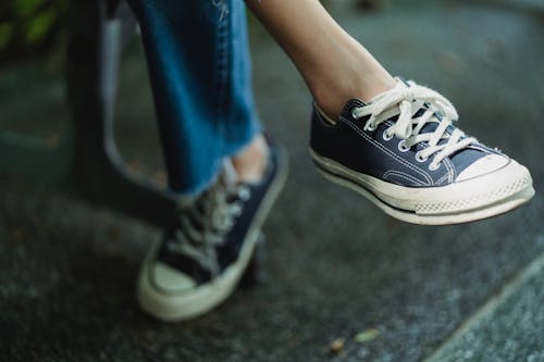 Faceless man in sneakers resting on piano · Free Stock Photo