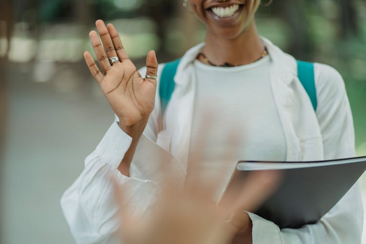 Smiling Woman Waving Her Hand