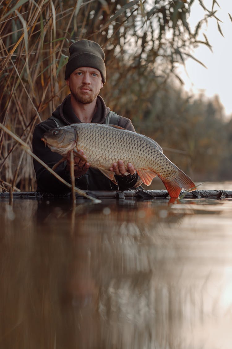 A Man Holding A Carp Fish