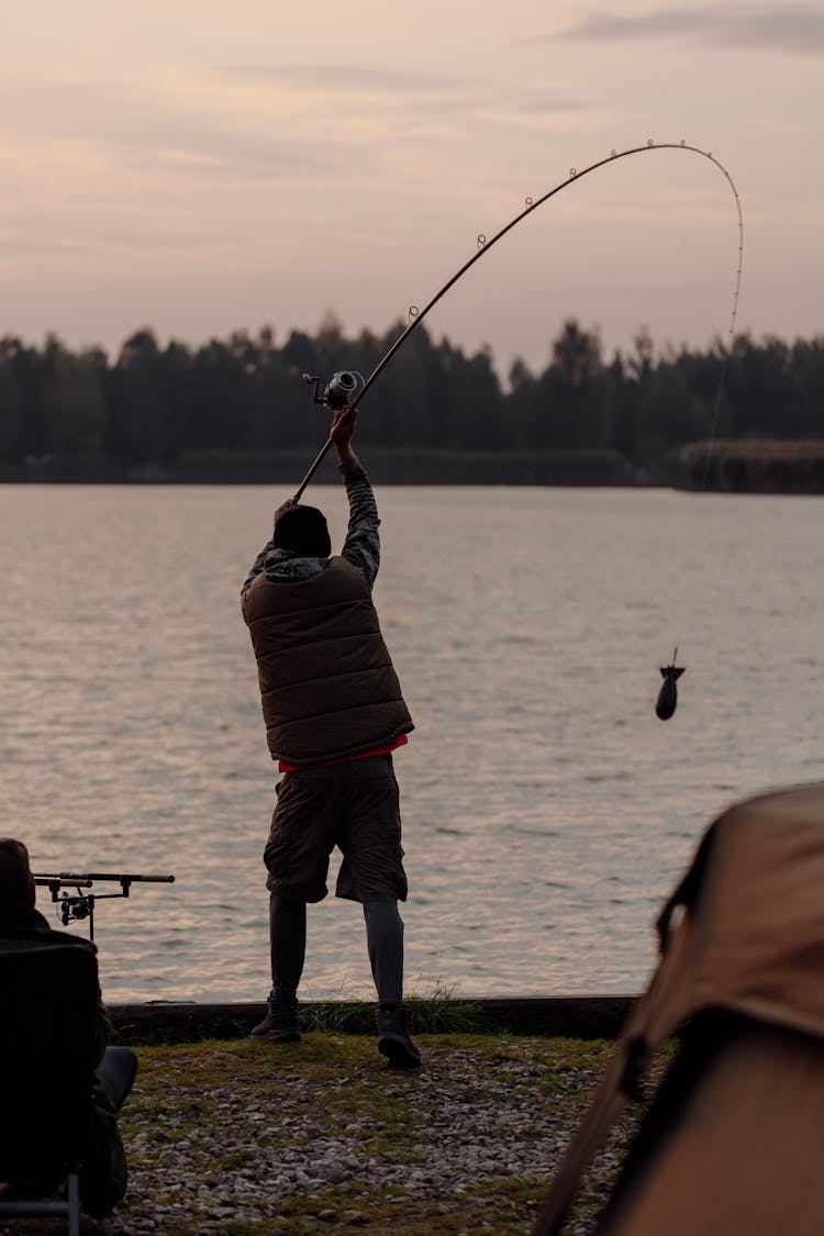 A Man Fishing In The Lake