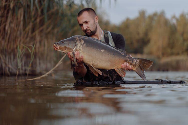 A Man Holding A Fish