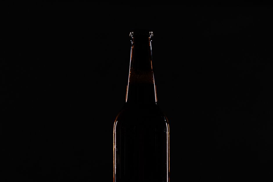 Dramatic lighting on a beverage bottle during a product shoot.