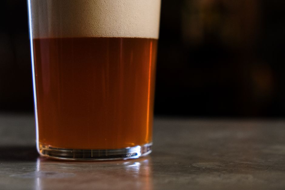 A close-up of a chilled bottle of <span class="notranslate"><em>Super Bock</em></span> with condensation glistening on the glass.