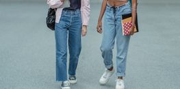 Crop unrecognizable multiethnic students walking together
