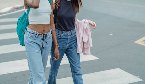 Young women walking on crosswalk